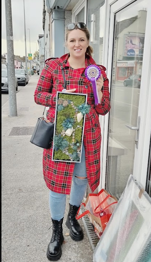 Me holding my art piece and first-place ribbon at the Rathcormac Autumn Show