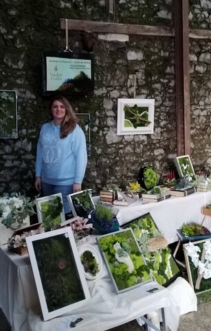 My Nádúr Crafts Christmas market stand with framed botanical artwork
