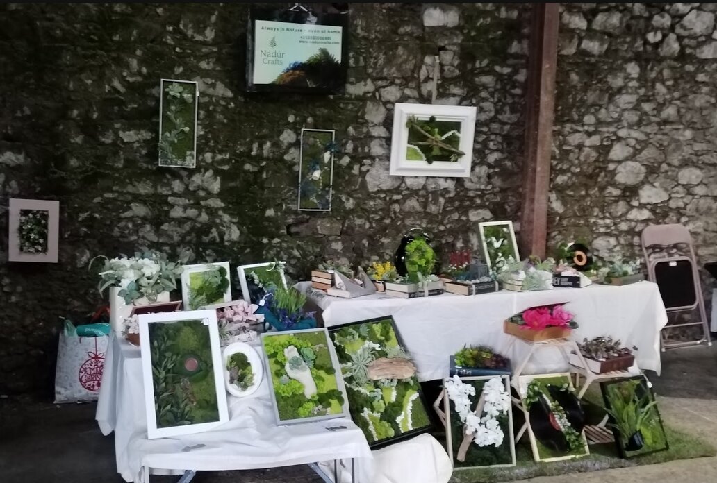 Nádúr Crafts artwork displayed across a Christmas market table and wall