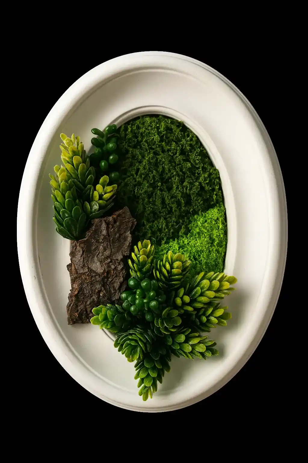 A white reclaimed dish arranged as a small moss and stone landscape